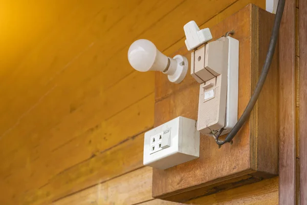 Cutouts and power plugs on old wooden walls
