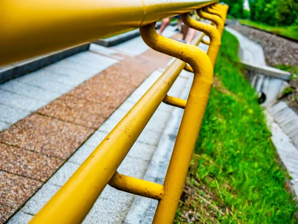 View on a yellow railing of a sidewalk — Stock Photo, Image