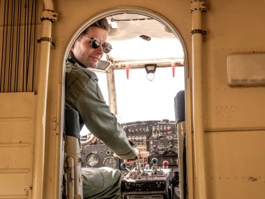 Kokpitte oturan yakışıklı bir genç pilot