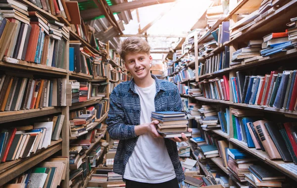 Щасливий Молодий Чоловік Стоїть Старій Атмосферній Бібліотеці Книгами Руках Посміхається — стокове фото