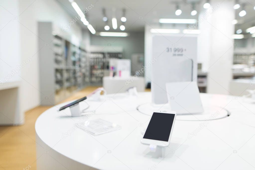 Smartphones on the background of the electronics store. Department of mobile phones in the tech store. A modern gadget store