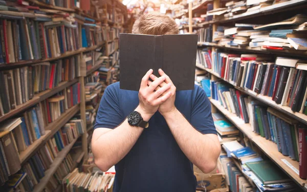 Portrait Man Standing Library Covers His Face Open Black Book — Stock Photo, Image