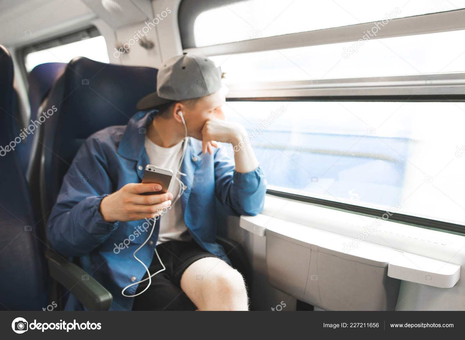 Young Man Looking Out Of Train Window Stock Photo - Download Image
