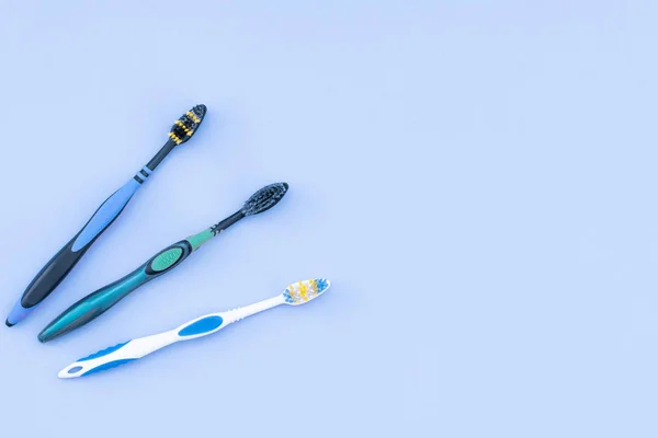 Three Toothbrushes Isolated Blue Background Copyspace Flat Lay Dental Care — Stock Photo, Image