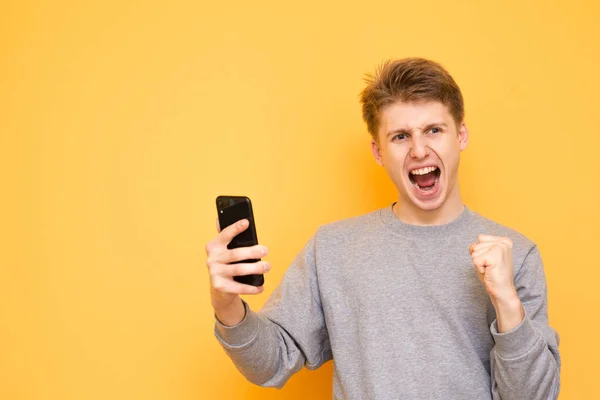 Portrait Emotional Guy Standing Yellow Background Making Gesture Winner Looking — Stock Photo, Image