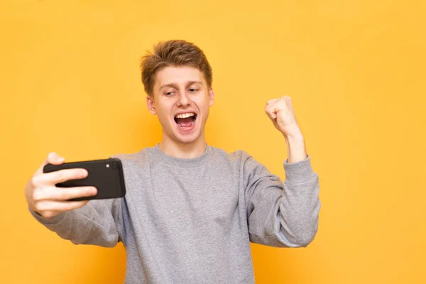 Portrait Guy Smartphone His Hand Looking Screen Rejoices Mobile Gamer — Stock Photo, Image