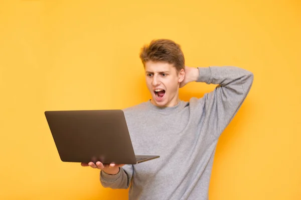 Emotional Young Man Holds Laptop His Hands Looks Screen Astonishment — Stock Photo, Image