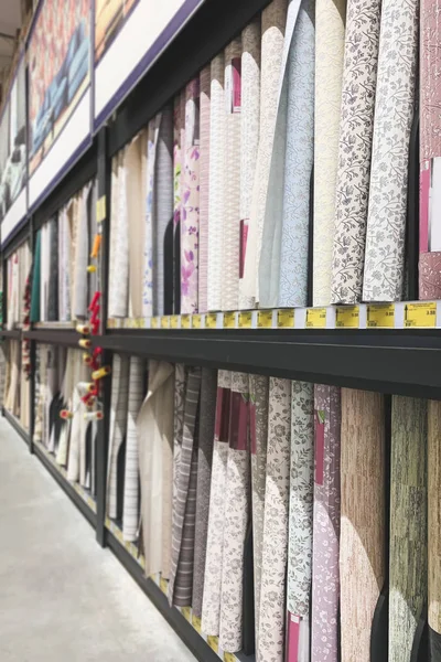 Shelves with roll of wallpaper in the shop for repair. Choosing and buying wallpapers from a large assortment.Background. Copyspace