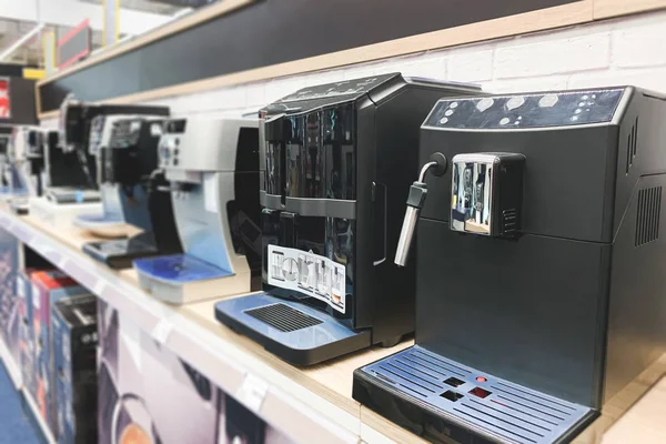 Coffee machines in a technology store. Choosing and buying a coffee machine on the shelves of the electronics store. Copyspace