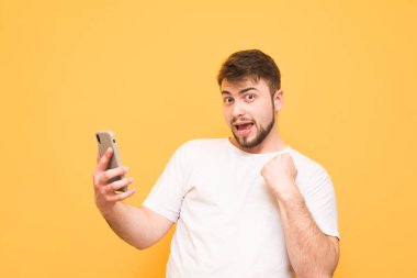 Adam kazandı, bakarak bir akıllı telefon elinde tutan