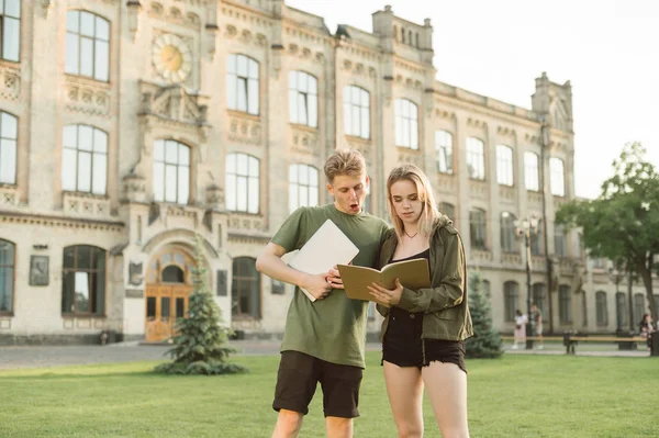 Two interested concentrated college students near the campus rea