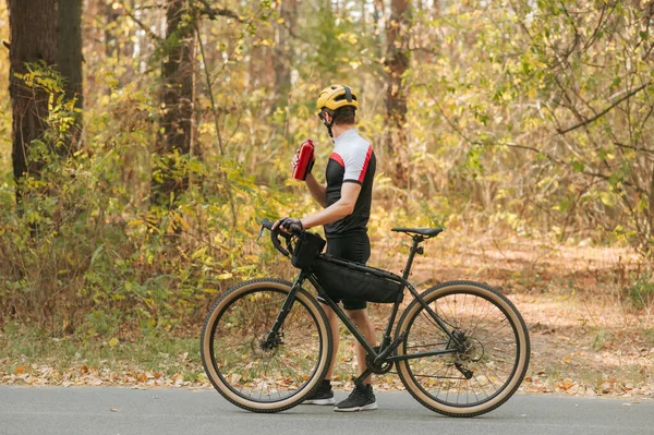 Male Cyclist Walking Autumn Park Bottle Water Hand Looking Away — Stock Photo, Image