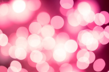 Pembe bir arka plan üzerinde parlak yuvarlak bokeh