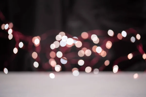 Blsck background with bright garland bokeh