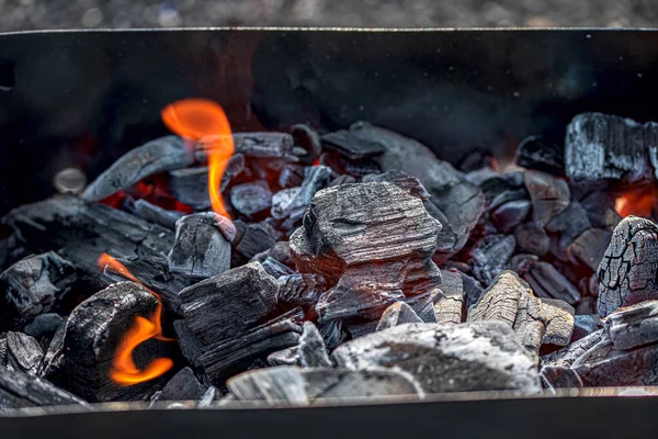 The burning black coals for a barbecue in a brazier — Stock Photo, Image