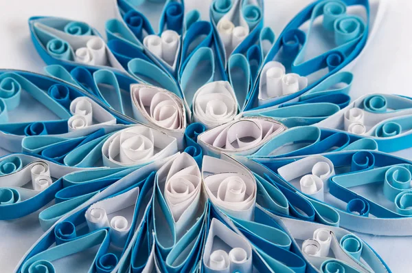 Blue-white quilling pattern on a white background