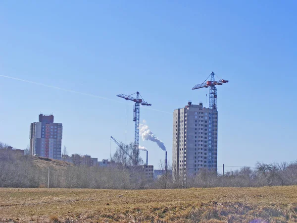 Skylines :cranes and building of waste neglected ground