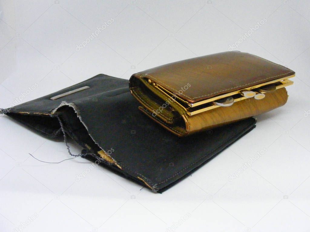 Old shabby empty wallet with elegant golden wallet with monney