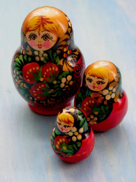 Family of matreshka. Matrioska russian doll on the blue wooden shabby background