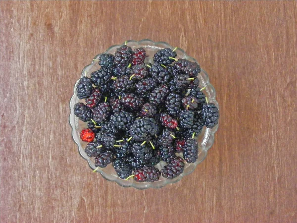 healthy black mulberry in crystal bowl. Close up