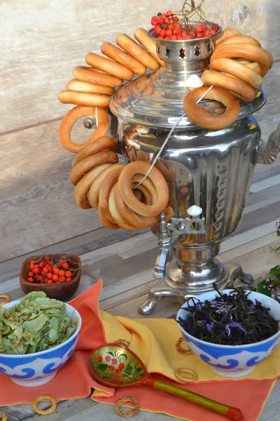 Samovar. Russian tradition of tea drinking. Bagels Russian sweets for tea. Vertical photo