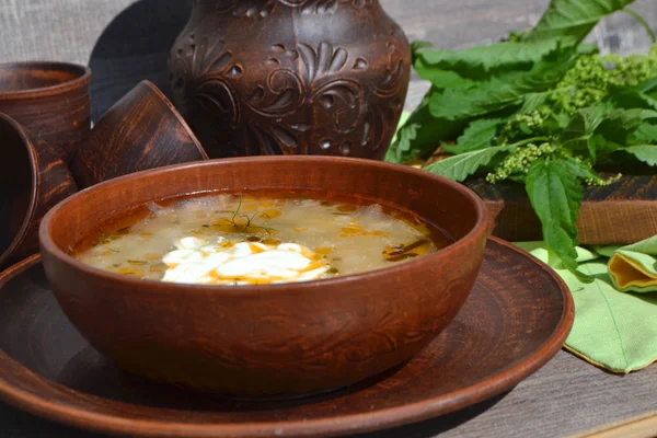 Spring vegetable soup nettle. Rustic table, country style — Stock Image Spring Vegetable Soup Nettle Rustic Table Country Style Royalty Free Stock Photos
