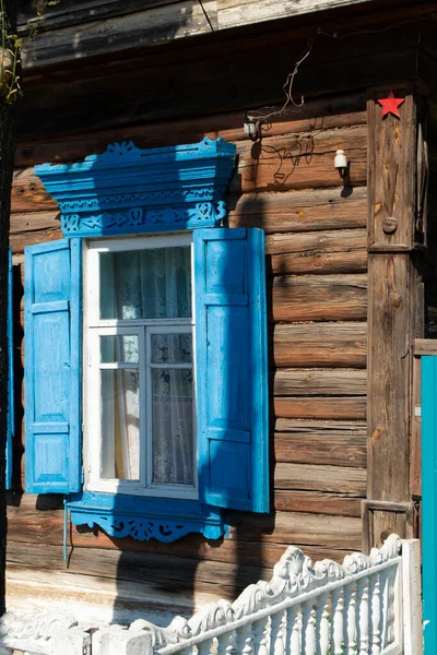 Vintage wooden carved window frame. Decorative lacy window frame in Belarus