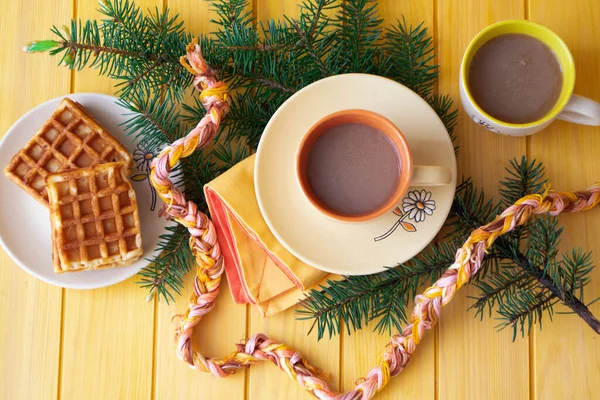 cups of hot cacao with belgian waffels, christmas hugge cozy home top view