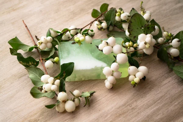 Natural soap with white berries on a wooden shabby table, spa procedures, body care, healthy lifestyle concept