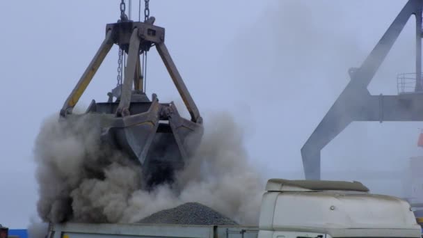 Grip kranen lossning cement klinker från fartyg till lastbil i flodhamn. Pråmleverans av dammande bulklast. Lossning och lastning av portalkran — Stockvideo