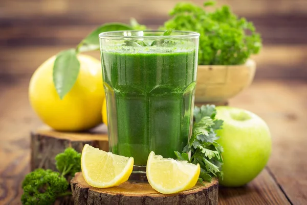 close up view of healthy smoothie drink with parsley and lemon