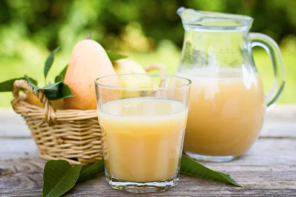 close up view of homemade pear juice on wooden table