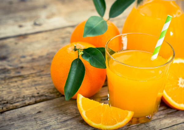 close up view of healthy orange juice on wooden table