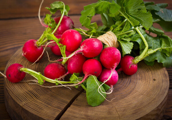 close up view of ripe radish on wooden background