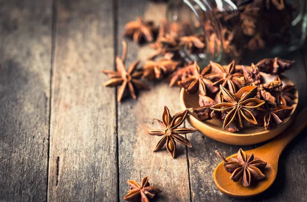 close up view of anise stars on wooden surface