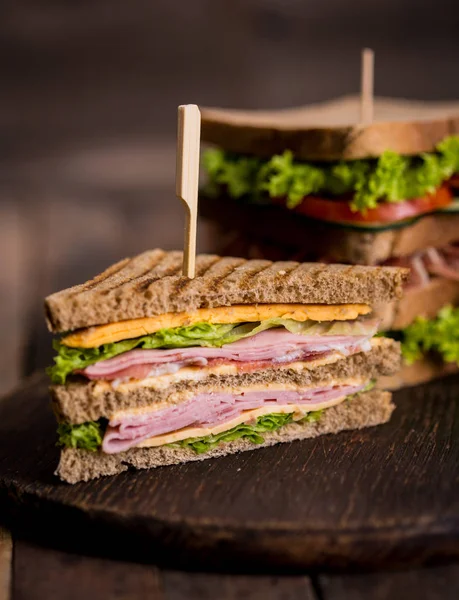 close up view of homemade sandwiches on wooden background