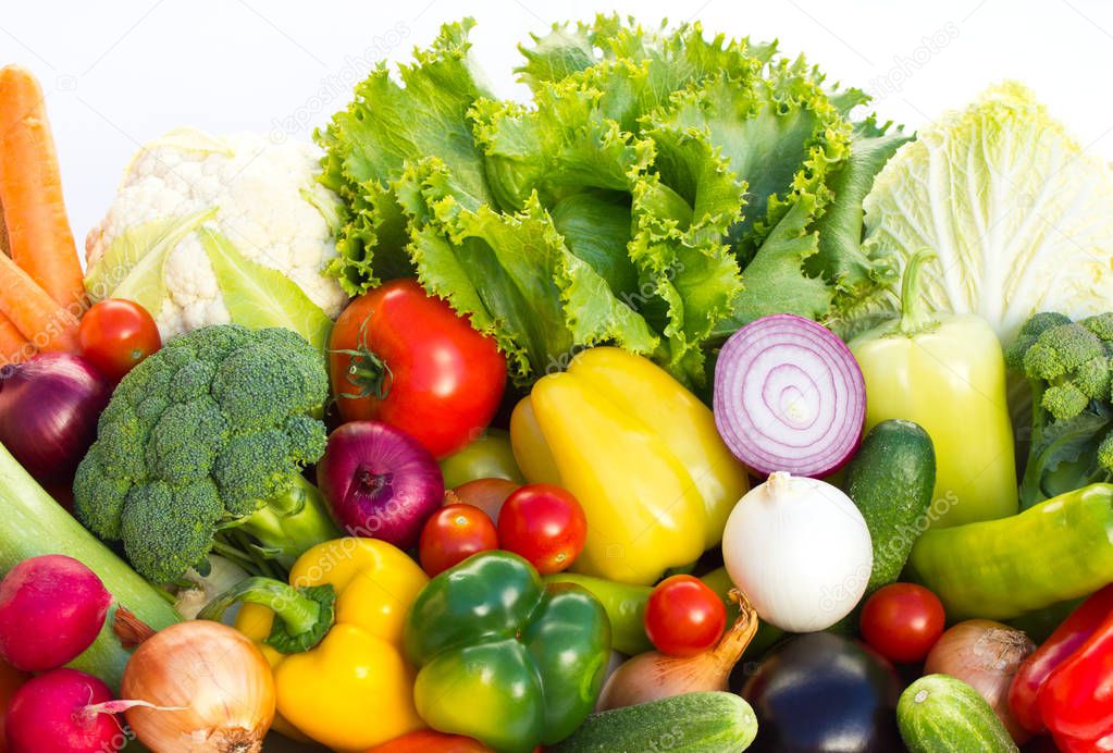 close up view of ripe vegetables arranged on white backdrop