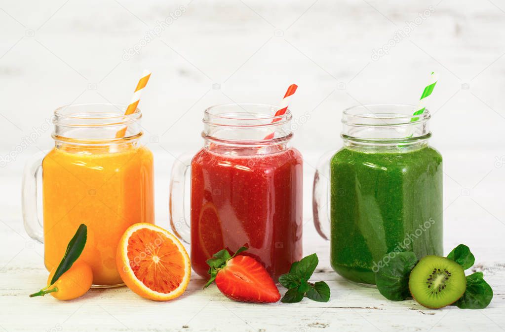 healthy fresh fruit drinks arranged on white background