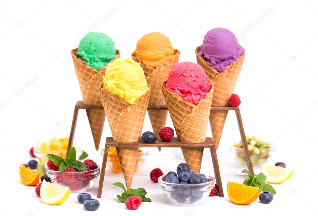 sweet ice cream in ice cream cones on white backdrop