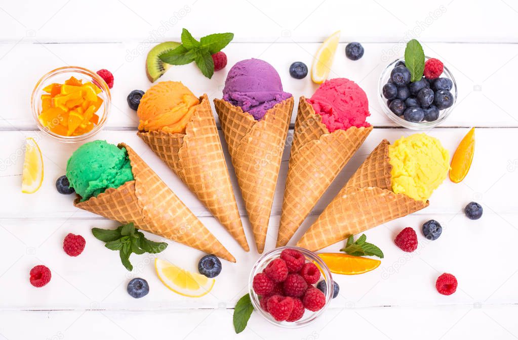 sweet ice cream in ice cream cones on wooden backdrop