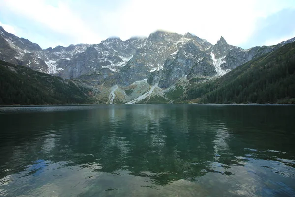 Picturesque  mountain lake Sea Eye, the Rybi Potok Valley. Poland. Morskie Oko is the largest mountain lake in the Tatra High mountains, near Zakopane, lying on the Polish side of the mountains, under the peak of Rysy (1395,4 m). October 6, 2018.