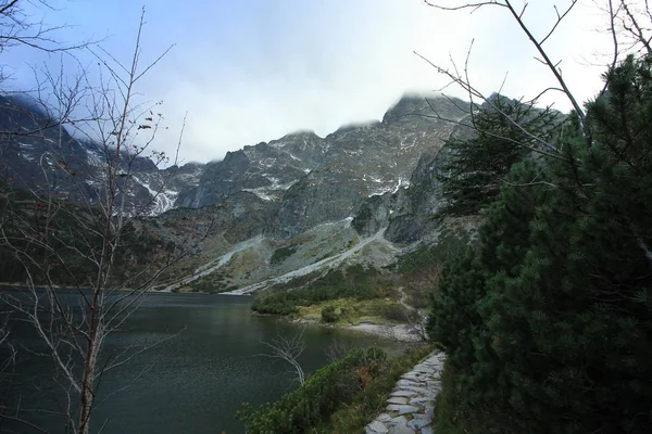 Picturesque  mountain lake Sea Eye, the Rybi Potok Valley. Poland. Morskie Oko is the largest mountain lake in the Tatra High mountains, near Zakopane, lying on the Polish side of the mountains, under the peak of Rysy (1395,4 m). October 6, 2018.