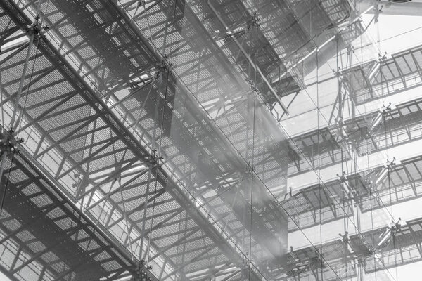 Steel structure roof of office building. Windows glass facade supported. Abstract architecture fragment background.