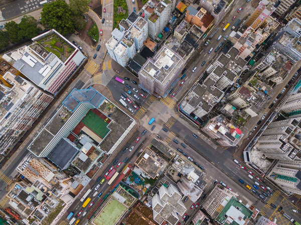 Cars with intersection streets in Sham Shui Po district. Architecture and transportation background. Aerial view of skyscraper buildings in Hong Kong, Top view