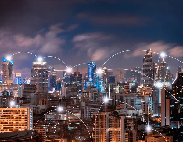 Digital network connection lines of Sathorn, Bangkok Downtown. Financial district and business centers in smart urban city in Asia. Skyscraper and high-rise buildings at night.