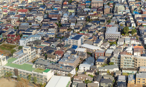 Aerial view of Tokyo apartments in cityscape background. Residential district in smart city in Asia. Buildings at noon. Japan