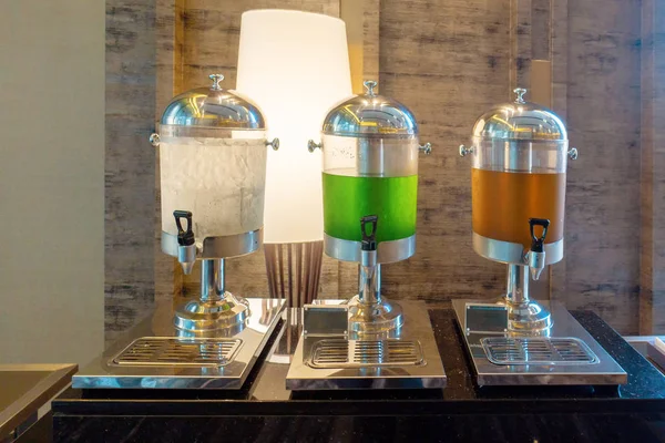 Hotel beverages dispensers. Drinking water, Guava and Orange juice in water cooler for guests of seminar for self service on a breakfast bar.
