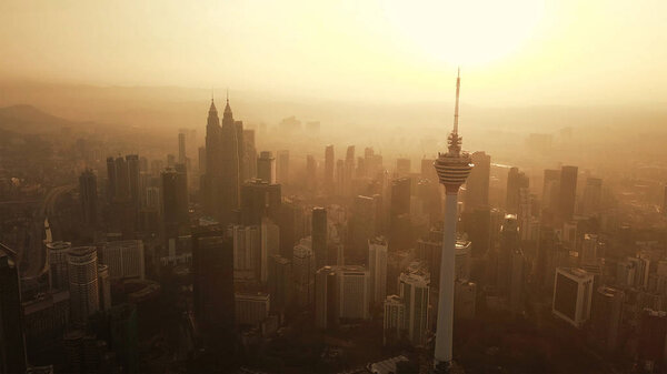 Menara Kuala Lumpur Tower with the sun. Aerial view of Kuala Lum