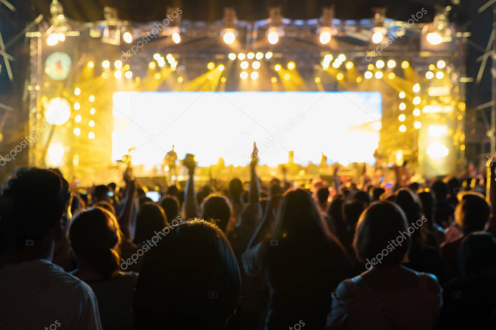 Silhouettes of crowd, group of people, cheering in live music co