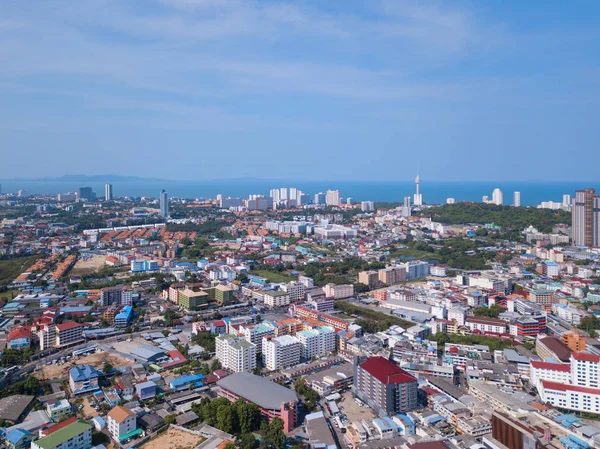 Aerial view of boats in Pattaya sea, beach, and urban city with